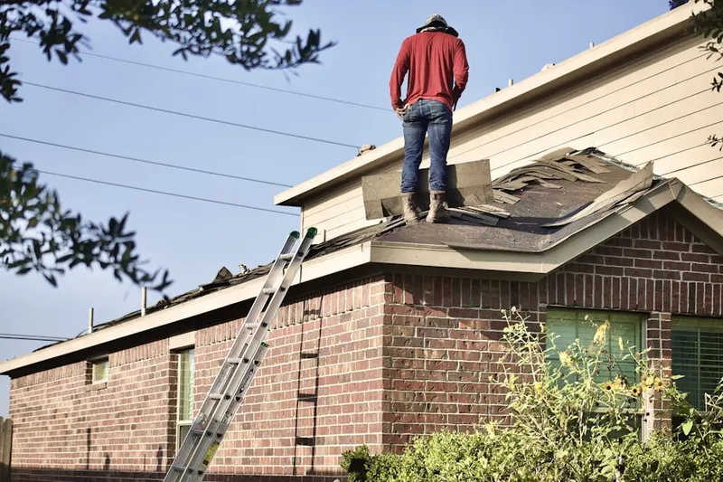 Professional roofer working on a residential roof in Riverview Estates